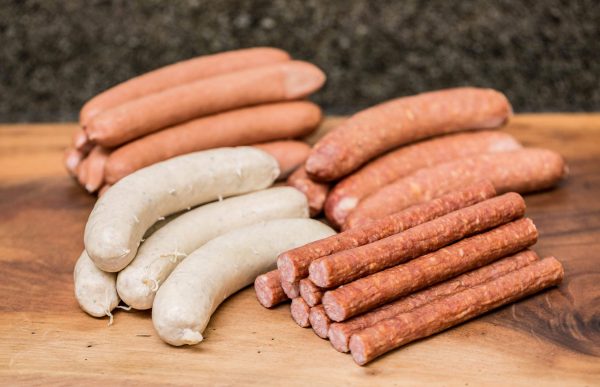 Grill pack sausages on cutting board