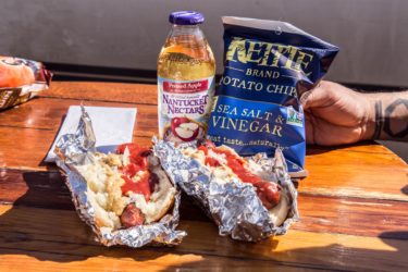 Otto&#039;s Sausages in buns with apple juice and chips